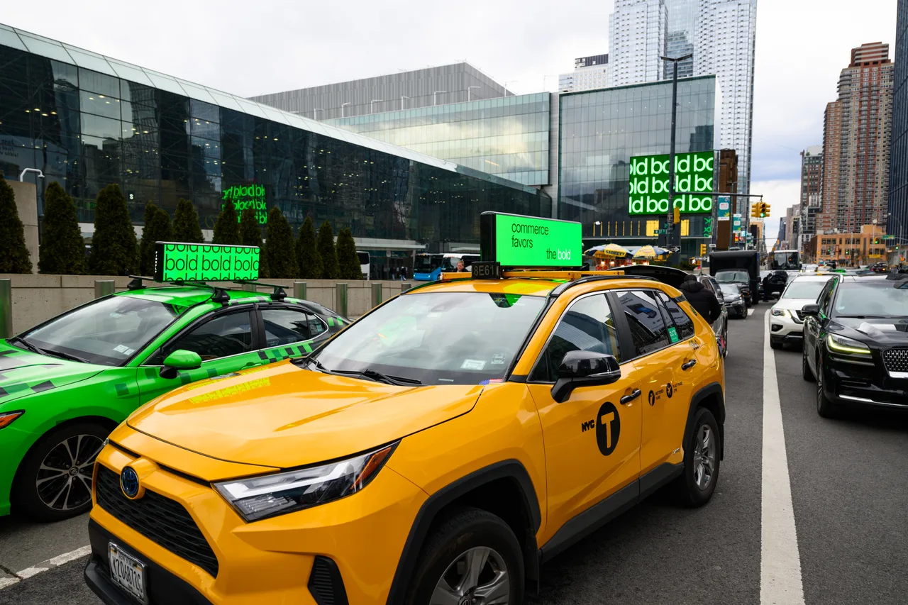 Shopify advertisement on a digital taxi top display on a New York City street